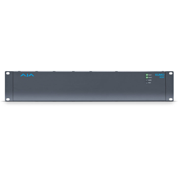 AJA KUMO 3232 compact 32x32 3G-SDI router with full-size BNC connectors, front-panel buttons, and LCD display in a 2RU rack-mounted unit.