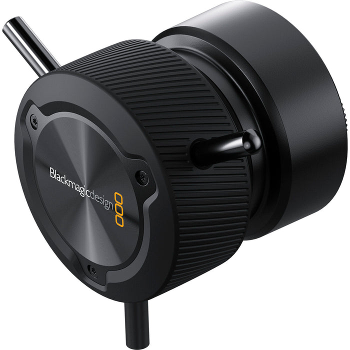 The Blackmagic Design Focus Demand (CINSTUDMFT/H/FD) is a precision focus control for Blackmagic Studio Cameras. It features a rotating knob with three levers, dual USB-C ports for daisy-chaining, and an ARRI-style rosette mount for tripod handles. Customizable buttons allow quick access to camera functions, enhancing efficiency in live productions.
