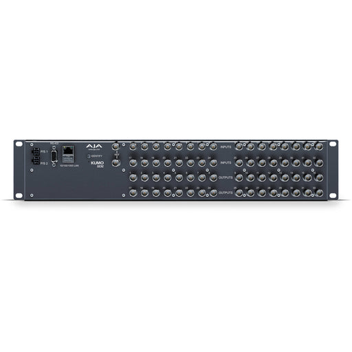 AJA KUMO 3232 compact 32x32 3G-SDI router with full-size BNC connectors, front-panel buttons, and LCD display in a 2RU rack-mounted unit.