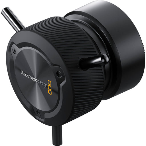 The Blackmagic Design Focus Demand (CINSTUDMFT/H/FD) is a precision focus control for Blackmagic Studio Cameras. It features a rotating knob with three levers, dual USB-C ports for daisy-chaining, and an ARRI-style rosette mount for tripod handles. Customizable buttons allow quick access to camera functions, enhancing efficiency in live productions.