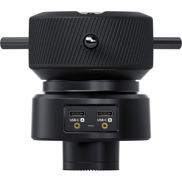 The Blackmagic Design Focus Demand (CINSTUDMFT/H/FD) is a precision focus control for Blackmagic Studio Cameras. It features a rotating knob with three levers, dual USB-C ports for daisy-chaining, and an ARRI-style rosette mount for tripod handles. Customizable buttons allow quick access to camera functions, enhancing efficiency in live productions.