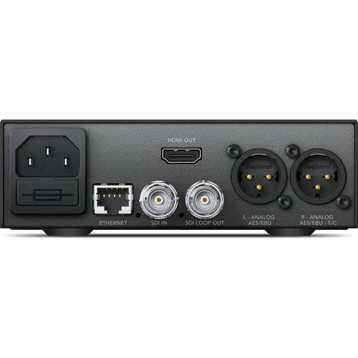 The Blackmagic Design Teranex Mini SDI to HDMI 12G Converter is a compact, rectangular device with a matte black finish. The front panel features a USB port and ventilation grilles, while the rear panel houses various connectors, including SDI input and loop output, HDMI output, Ethernet port, and XLR audio outputs. This design facilitates professional video and audio signal conversion in broadcast and post-production environments.