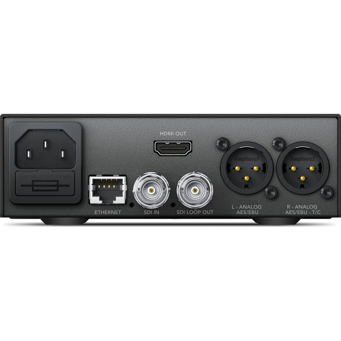 The Blackmagic Design Teranex Mini SDI to HDMI 12G Converter is a compact, rectangular device with a matte black finish. The front panel features a USB port and ventilation grilles, while the rear panel houses various connectors, including SDI input and loop output, HDMI output, Ethernet port, and XLR audio outputs. This design facilitates professional video and audio signal conversion in broadcast and post-production environments.