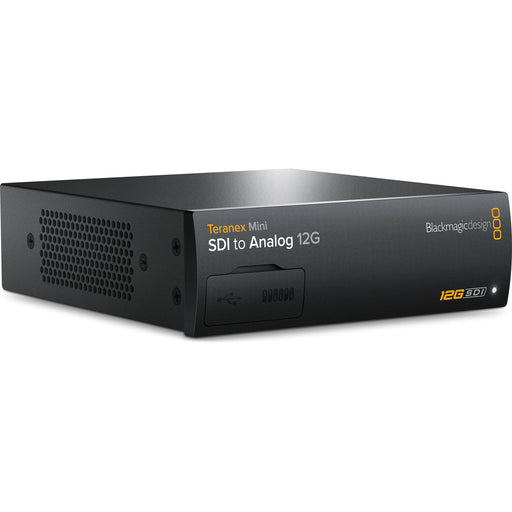 The Blackmagic Design Teranex Mini SDI to Analog 12G Converter is a compact, rectangular device with a matte black finish. The front panel features a USB port and ventilation grilles, while the rear panel includes a 12G-SDI input, a loop-through SDI output, component, S-Video, and composite analog video outputs, an Ethernet port, and XLR audio outputs. This design facilitates professional video and audio signal conversion in broadcast and post-production environments.