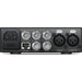 The Blackmagic Design Teranex Mini Analog to SDI 12G Converter is a compact, rectangular device with a matte black finish. The front panel features a USB port and ventilation grilles, while the rear panel includes component, S-Video, and composite analog video inputs, two 12G-SDI outputs, an Ethernet port, and XLR audio inputs. This design facilitates professional video and audio signal conversion in broadcast and post-production environments.