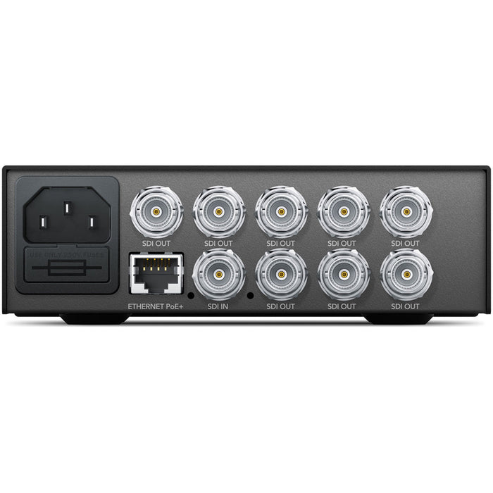 The Blackmagic Design Teranex Mini SDI to DisplayPort 8K HDR Converter is a compact, rectangular device with a matte black finish. The front panel features a color LCD screen, control buttons, and a rotary knob for easy navigation and settings adjustment. The rear panel includes four 12G-SDI inputs, four 12G-SDI loop outputs, two full-size DisplayPort outputs, one USB-C DisplayPort output, two analog audio outputs via RCA connectors, an Ethernet port, and a standard IEC power input.