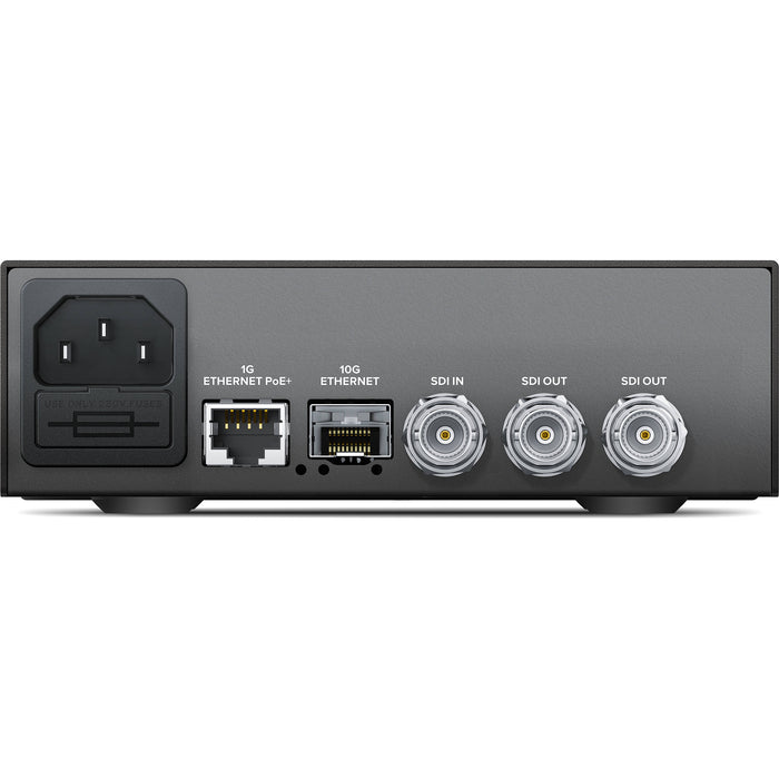 The Blackmagic Design Teranex Mini IP Video 12G Converter is a compact, rectangular device with a matte black finish. The front panel features a USB port and ventilation grilles, while the rear panel includes a 12G-SDI input, two 12G-SDI outputs, a Gigabit Ethernet port, an SFP+ cage for optional 10G Ethernet modules, and a standard IEC power input. This design facilitates bi-directional conversion between 12G-SDI signals and IP video streams, supporting video formats up to DCI 4K at 60p. 
