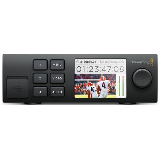 The Blackmagic Design Teranex Mini SDI to HDMI 8K HDR Converter is a compact, rectangular device with a matte black finish. The front panel features a color LCD screen, control buttons, and a rotary knob for easy navigation and monitoring. The rear panel includes four 12G-SDI inputs, four HDMI 2.0 outputs, analog audio outputs, a USB Type-C port, and an Ethernet port. This design facilitates the conversion of SDI sources to HDMI in various formats, including HD, Ultra HD, and 8K.