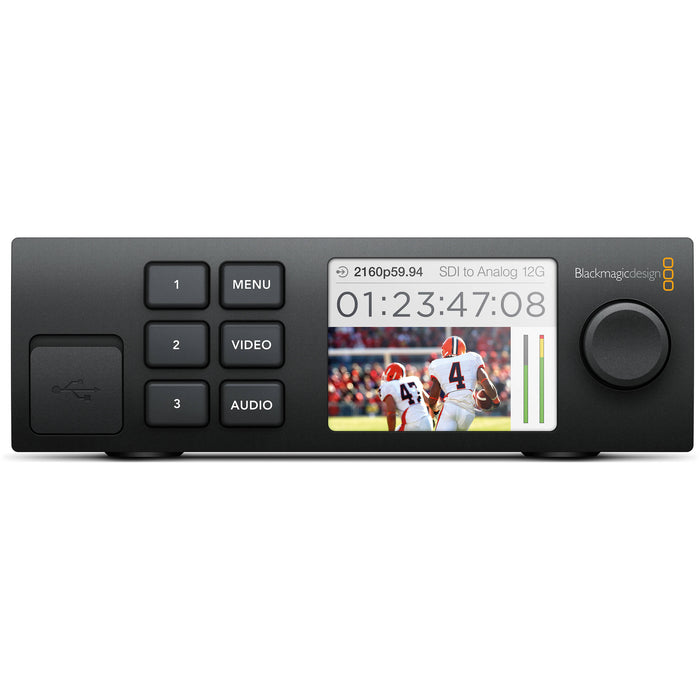 The Blackmagic Design Teranex Mini SDI to HDMI 8K HDR Converter is a compact, rectangular device with a matte black finish. The front panel features a color LCD screen, control buttons, and a rotary knob for easy navigation and monitoring. The rear panel includes four 12G-SDI inputs, four HDMI 2.0 outputs, analog audio outputs, a USB Type-C port, and an Ethernet port. This design facilitates the conversion of SDI sources to HDMI in various formats, including HD, Ultra HD, and 8K.