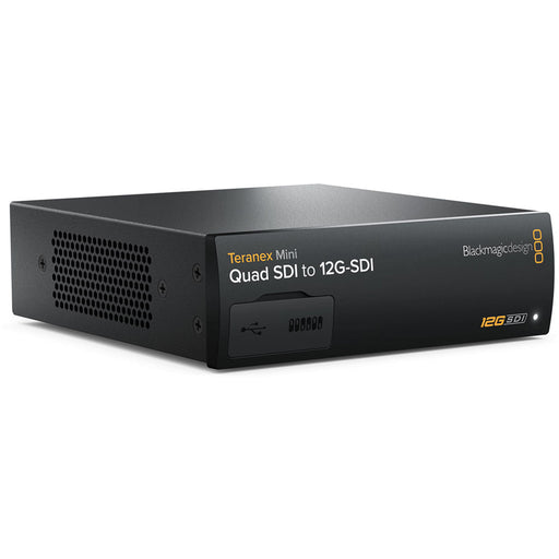 The Blackmagic Design Teranex Mini Quad SDI to 12G-SDI Converter is a compact, rectangular device with a matte black finish. The front panel features a USB port and ventilation grilles, while the rear panel includes four 12G-SDI inputs, a single 12G-SDI output, an Ethernet port, and a standard IEC power input. This design facilitates the conversion of Quad-Link SDI sources to a single 12G-SDI output, streamlining connectivity in professional broadcast and post-production environments.